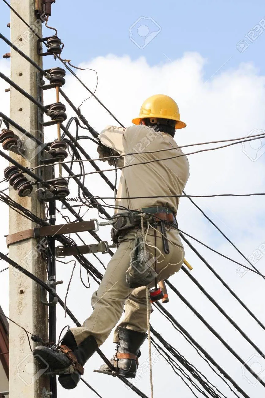 Download Professional Electrician Fixing An Electrical Post Wallpaper