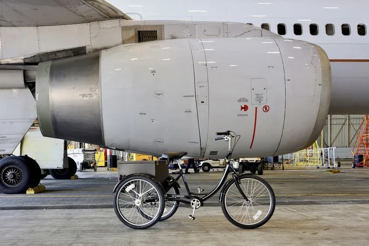 Husky Tricycle Parked Next To Boeing 757 Engine