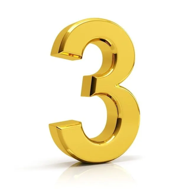 The Number Three In Gold On A White Background